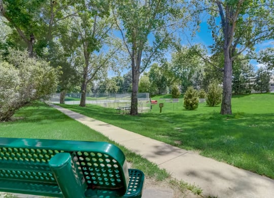Bench with a  dog park in the background at Governor's Park, Fort Collins, 80525